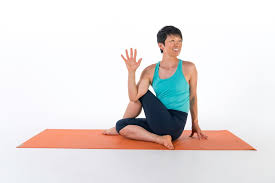Girl doing Seated Spinal Twists