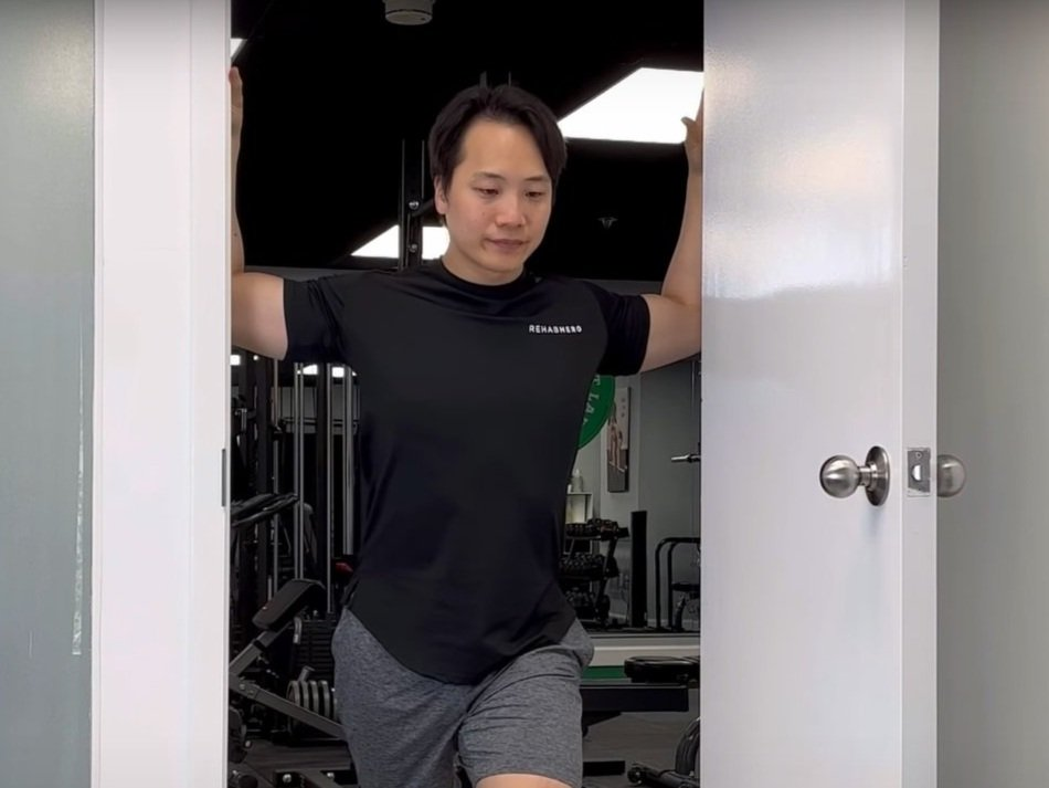 Man doing Upper Chest Stretch in door